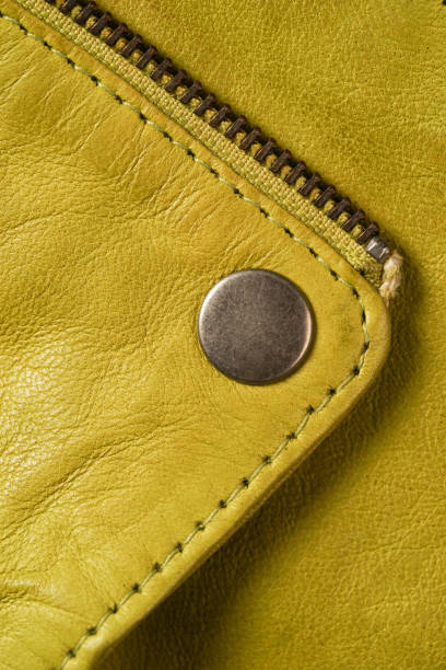 istock Metal clasp button on yellow leather jacket. macro detail 691870810