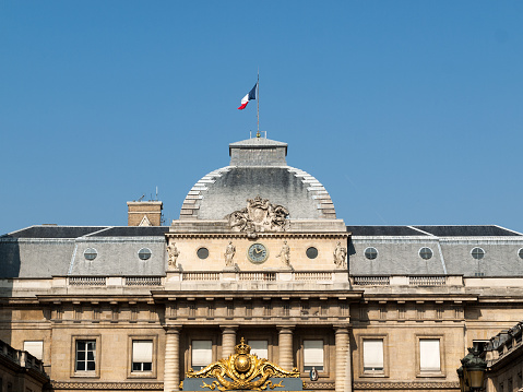 Paris : Hotel de Matignon entrance,  with french flag. It's a State building of french administration, where the first minister (head of government) work, with all his team, senior official and official or public servant. Situated rue de Varenne in Paris, 7 th district – arrondissement – in France.