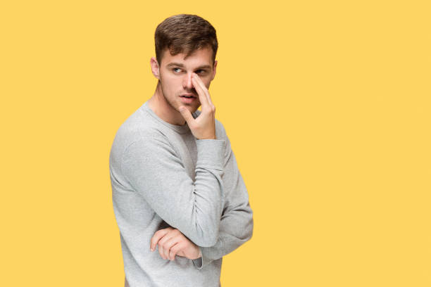 istock The young serious man looking cautiously and Speaking secret 691871694