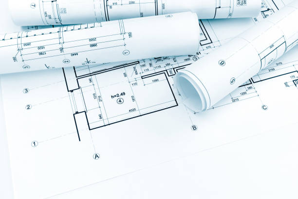 istock rolled architectural plans and technical drawings on house blueprint 691882694