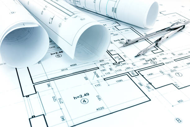 istock rolls of blueprints, drawing compass and architectural plan of apartments 691885910