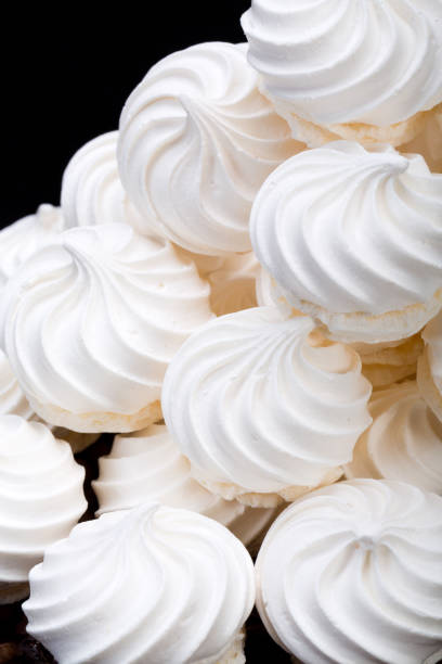 istock French vanilla meringue cookies on black background 691885930