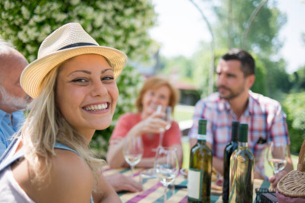 Family holidays in Langhe region, Piedmont, Italy: Drinking wine and eating food outdoor Family holidays in Langhe region, Piedmont, Italy: Drinking wine and eating food outdoor agritourism stock pictures, royalty-free photos & images