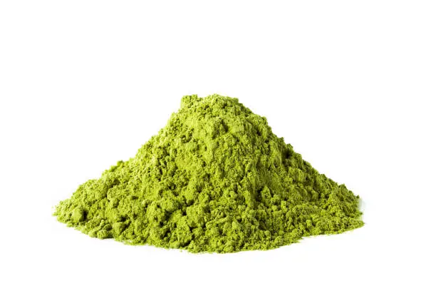 Heap of green matcha tea powder isolated on white background