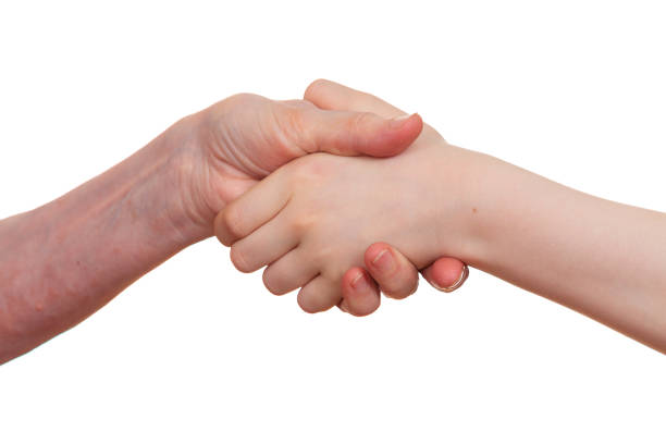 istock Handshake between an old person with a wrinkled hand and a kid 691898886