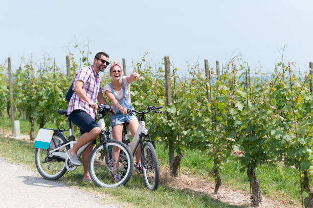 Family holidays in Langhe region, Piedmont, Italy: Electric bikes trip in the hills Family holidays in Langhe region, Piedmont, Italy: Electric bikes trip in the hills agritourism stock pictures, royalty-free photos & images