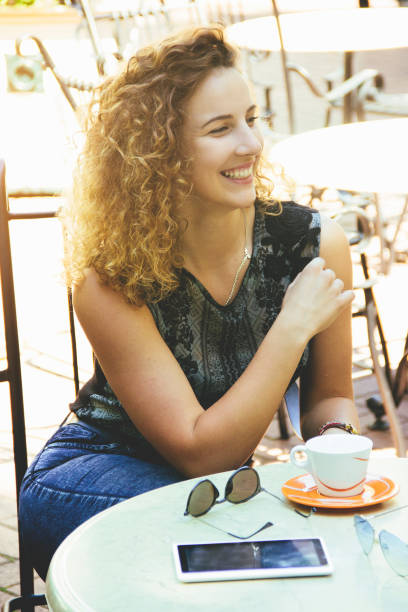 istock Laughing beautiful curly girl in cafe 691913932