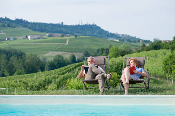 Family holidays in Langhe region, Piedmont, Italy: Relax by the swimming pool Family holidays in Langhe region, Piedmont, Italy: Relax by the swimming pool agritourism stock pictures, royalty-free photos & images