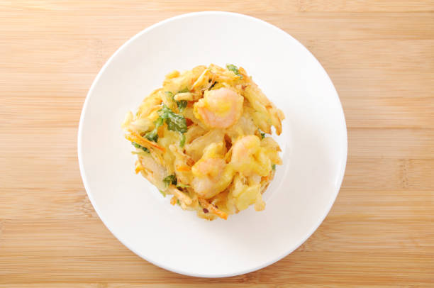 kakiage tempura shrimp vegetable on plate on table cutting board