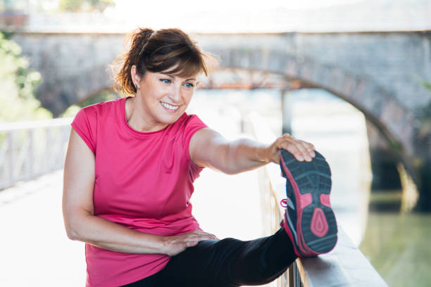 istock Middle aged woman stretching legs on a trail 691920164