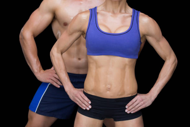 istock gym couple posing with hands on hips 691927664