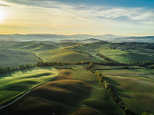 Tuscany landscape at sunrise with low fog