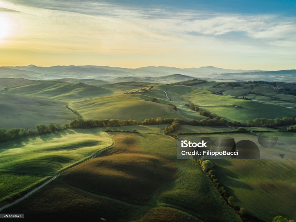 Tuscany landscape at sunrise with low fog Tuscany landscape at sunrise with low fog. Landscape - Scenery Stock Photo