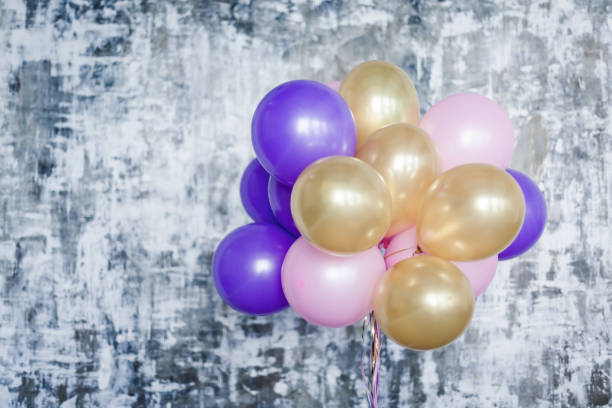 istock Bright balloons bunch against a textured wall 691930978