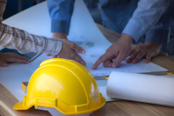 istock Safety helmet placed on a meeting table engineering team. /Selective focus at safety helmet. 691931046