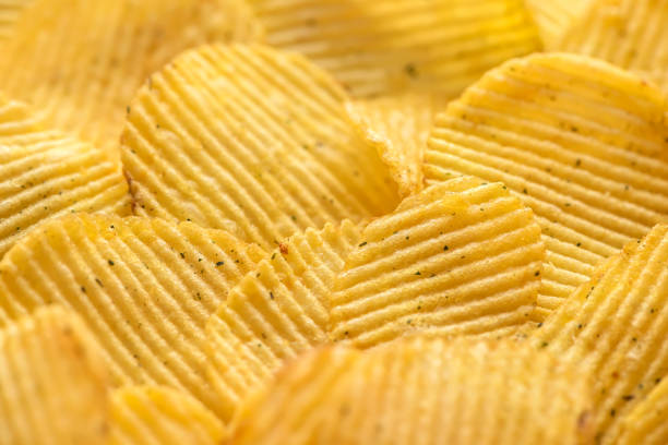 istock close up rippled natural potato chips with salt and greenery 691933564