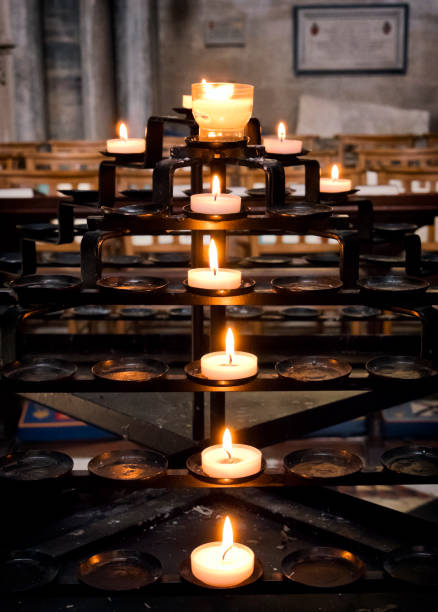 Lighted candles in Ely Cathedral Metal candle holder with lighted candles in Ely Cathedral, Ely, Cambridgeshire, eastern England. ely england photos stock pictures, royalty-free photos & images