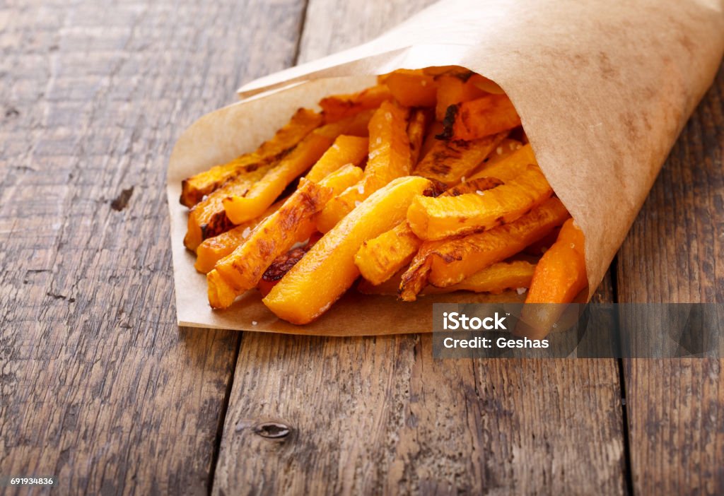 Baked butternut squash fries with sea salt. Pumpkin chips. French Fries Stock Photo