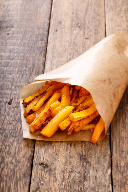 istock Baked butternut squash fries with sea salt. Pumpkin chips. 691934838