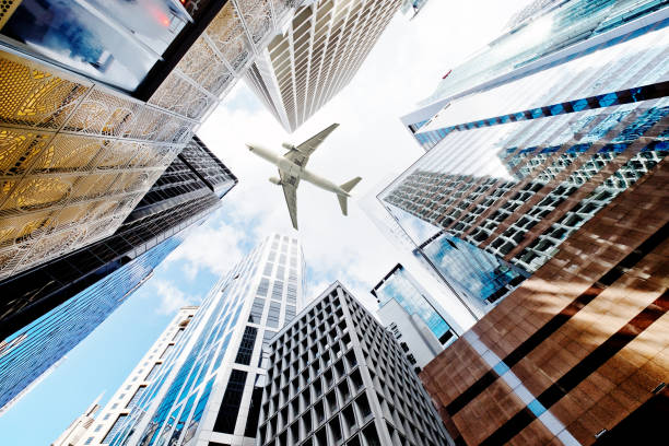 istock Airplane flying over business skyscrapers 691943098