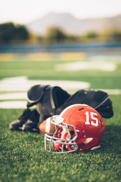 istock Red Football Helmet on Field 691943588