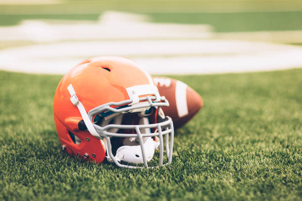 istock Orange Football Helmet on Field 691943594