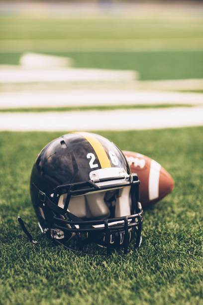 istock Black Football Helmet on Field 691943610