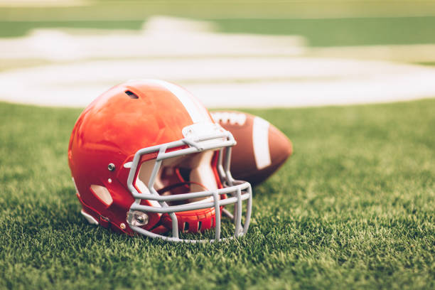 istock Red Football Helmet on Field 691943612