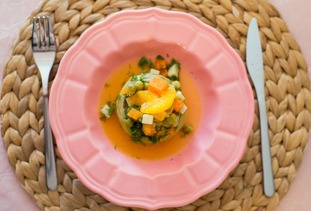 orange artischocke - artichoke artichoke heart salad portion stock-fotos und bilder
