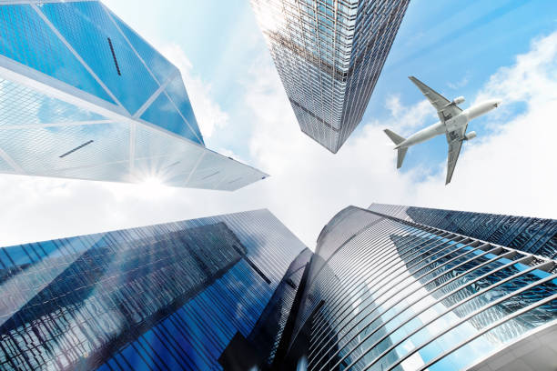 istock Airplane flying over business skyscrapers 691949244
