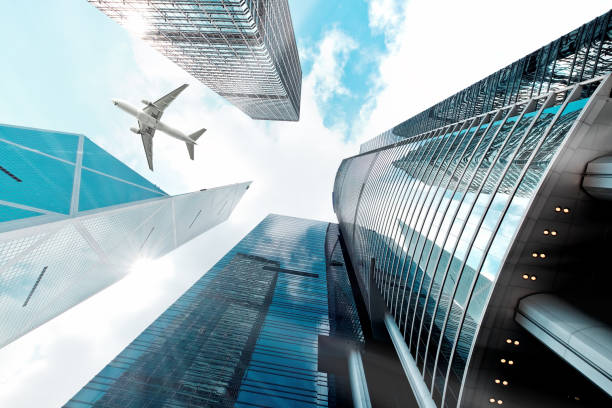 istock Airplane flying over business skyscrapers 691959010