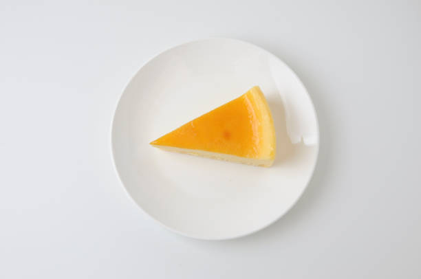 istock piece of fresh cheese cake on plate isolated on white background 691959156