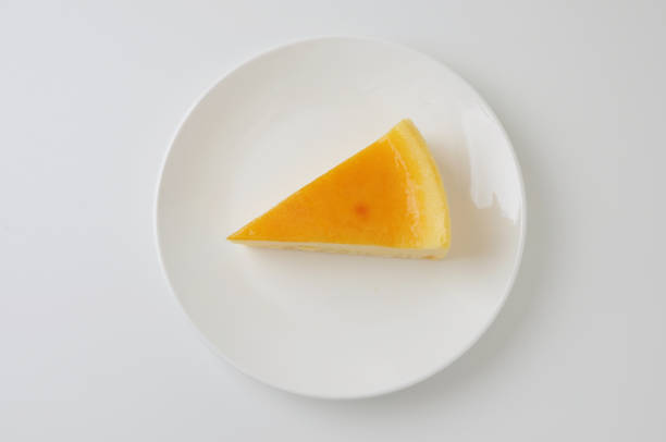 istock piece of fresh cheese cake on plate isolated on white background 691959414