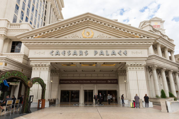 Caesars Palace Entrance Las Vegas, USA - October 28, 2016:  People entering Caesars Palace on the Vegas Strip in Las Vegas, NV.  Caesars Palace is a luxury resort, famous casino, and an iconic brand. warwick uk stock pictures, royalty-free photos & images