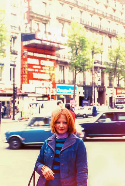 Vintage image from the seventies featuring a woman in the streets of Paris.