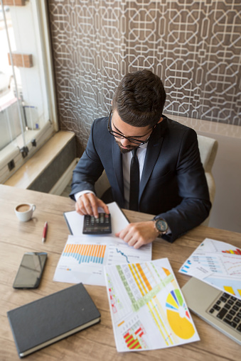 Shallow depth of field of accountant calculating financial data