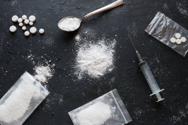 set of different drugs - powder and pills and a syringe on a black background - alcohol drug abuse alcoholism pill imagens e fotografias de stock