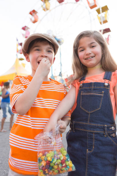 istock Boy and Girl Sharing Snack at a Carnival 691987700