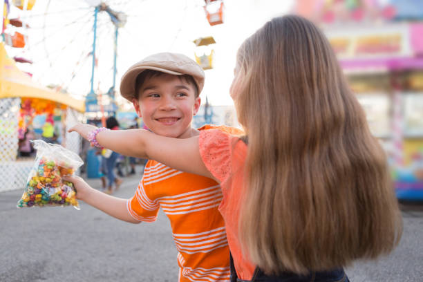 istock Boy and Girl Sharing Snack at a Carnival 691988482