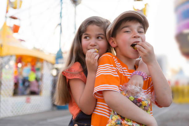 Boy and Girl Sharing Snack at a Carnival