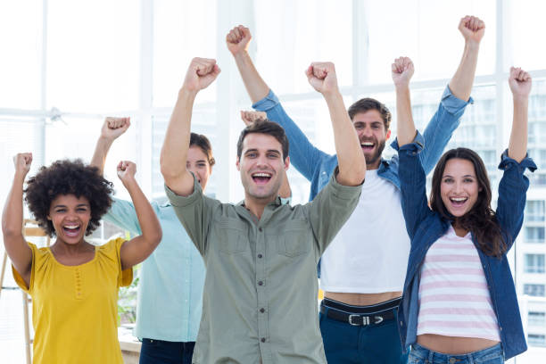 istock Young creative business people gesturing arm up 691988768