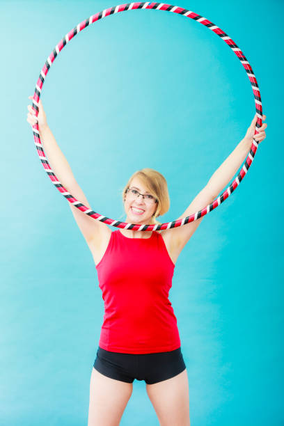 istock Fit woman with hula hoop doing exercise 691988774