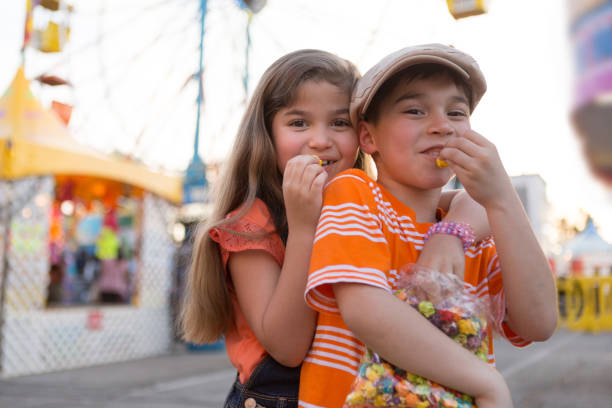 istock Boy and Girl Sharing Snack at a Carnival 691988808
