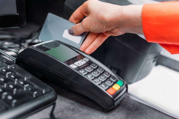 istock Close-up partial view of person using payment terminal and credit card 691991792