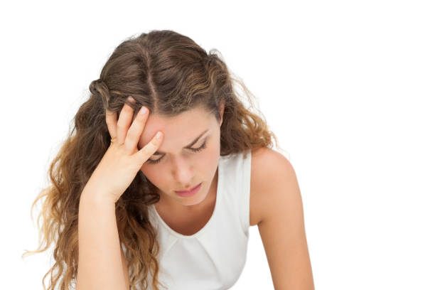 Close-up of a sad young woman over white background