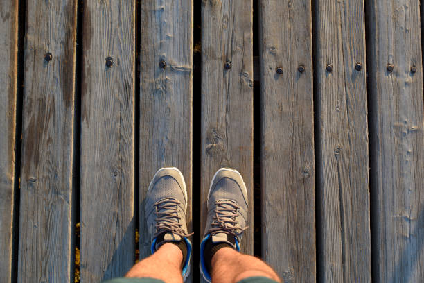 istock man sport shoe on wooden floor 691995586