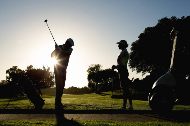 istock Golfing couple teeing off for the day 692000970
