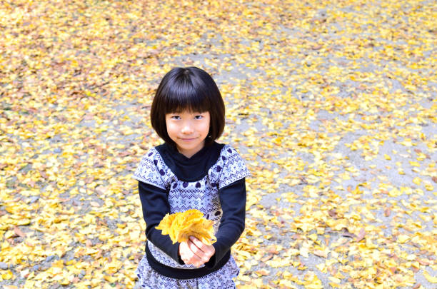 istock Girl enjoying autumn leaves 692011398