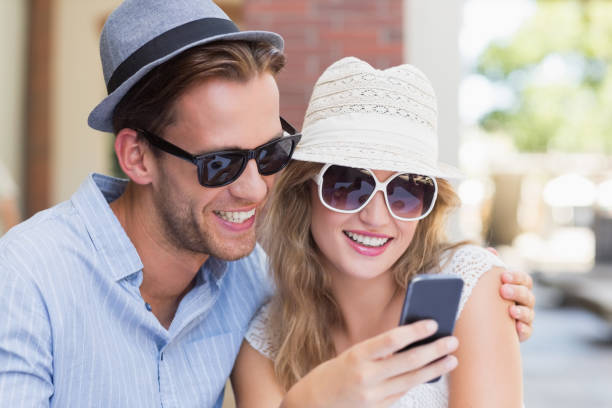 istock Cute couple looking at their smartphone 692014028