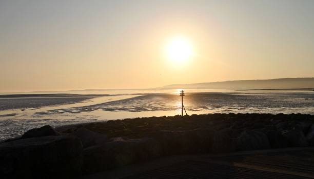 istock Golden sunset at rocky beach 692021918